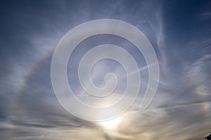 Sun halo in blue sky on bright winter day