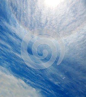 Sun halo in blue sky with clouds