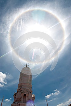 Sun halo or corona phenomenon in cloudy and blue the sky.