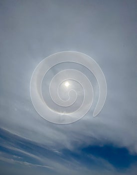 Sun with halo effect on sky with cloud