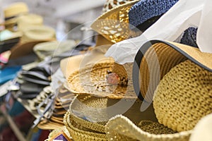 Sun hats stacked for sale at the beach.