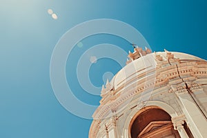 Sun illuminating the top of the pantheon with blue background