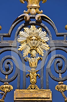 The Sun king, detail of the metal gate of the Chateau de Versailles, Paris