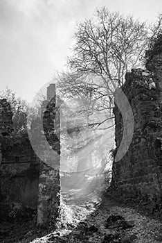 Sun light over ruins of ancient catholic church in Italy - black and white photo