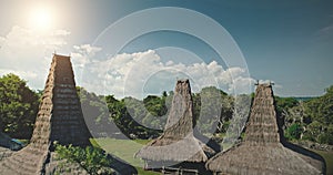 Sun light at straw roof of traditional house in Kodi village, Indonesia. Aerial Asia landmark view photo