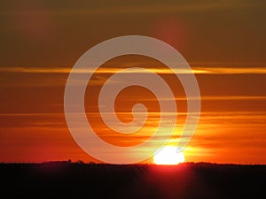 sun like fireball in a red lit sunset