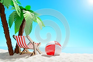 Sun lounger and beach ball under a palm tree on the sandy coast. Sky with copy space