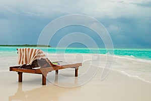 Sun lounger on tropical beach photo