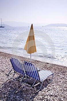 Sun lounger and umbrella on empt beach