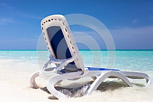 Sun lounger in the water on the beach