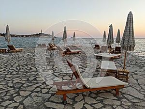 Sun loungers and beach umbrellas on the beach in Rovinj, Istria in Croatia