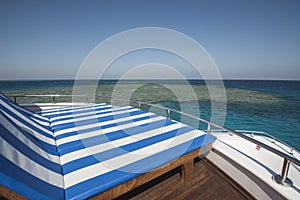 Sun loungers on the bow of a large luxury motor yacht