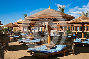 Sun loungers on an empty beach. empty deck chairs. sun canopy