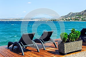 Sun loungers on the pier. Nice view of Salamis island . in Greece