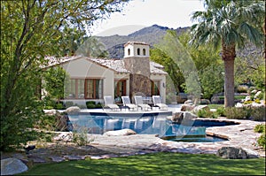 Sun loungers at poolside in luxury mansion