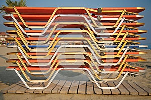 Sun loungers stacked on beach