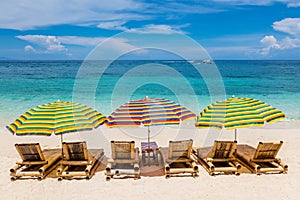 Sun lounges with umbrellas at Ilig Iligan Beach, Boracay Island, Philippines