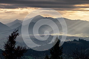 The sun magically shines through a gap through the cloud producing amazing sun ray in the sky