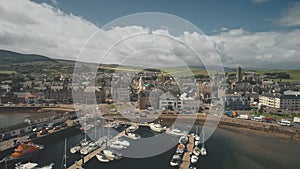 Sun marina with ships, yachts aerial. Epic cityscape of harbor town of Campbeltown, Scotland, Europe