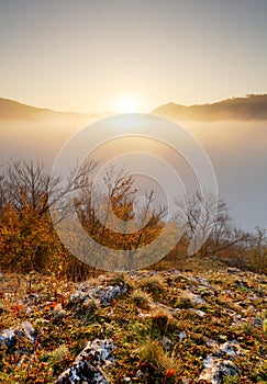 Slunce nad mraky mlha v horské krajině při východu slunce