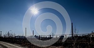 The sun over the high, emission-generating chimneys of the zinc and lead smelter in Miasteczko Slaskie