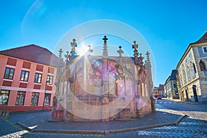 The sun over Kamenna Kasna Stone Fountain, Kutna Hora, Czech Republic