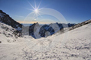 Sun over Sedlo Vaha saddle in High Tatras during winter
