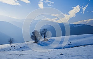 Sun over the winter mountains with snow