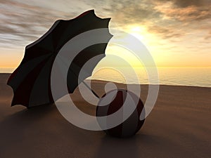 Sun parasol and beach ball on a beach at sunset.