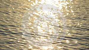 Sun path on water with golden sun light shimmering in sun