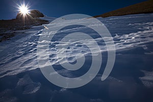 Sun on peak of mountain