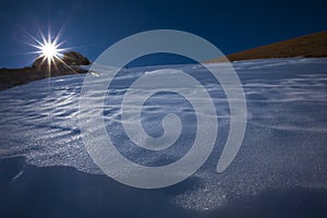 Sun on peak of mountain