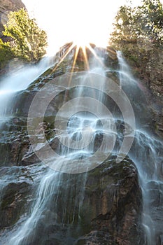 Sun Peeking Out Above Waterfall with Long Exposure