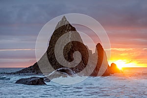 Sun peeking through stormy clouds at Martins Beach