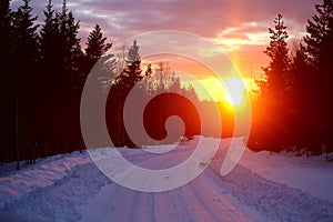 Sun pillar over winterly road in lapland photo