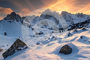 Sun Setting Over Snowy Mountain Range