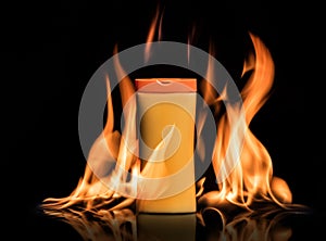 Sun protection cream, lotion stands in a fire on the black background