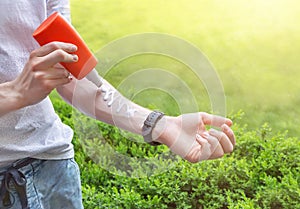 Sun protection. Hand of caucasian man applying sun cream sunscreen from a plastic container bottle to protect skin.