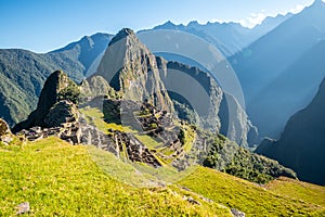 Sun rays above Inca ruins of Machu Picchu archeological site, Cusco, Peru, South America