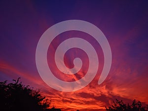 Sun rays beetween the clouds in a sunset sky .