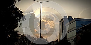 Sun rays behinds from clouds in the city