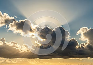 Sun rays burst through thick, dark