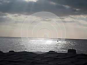 Sun rays through clouds over the sea