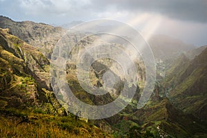 Sun rays coming through the clouds in rocky mountain landscape of in Xo-xo valley in Santo Antao island, Cape Verde