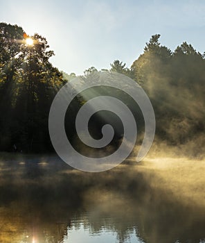 Sun rays coming through the trees onto water in the Blue Ridge Mountains