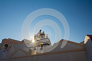 Sun rays diffraction at church, Santorini, Greece
