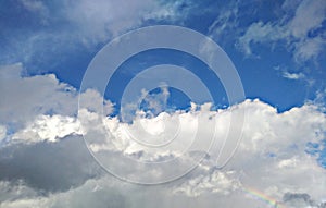 Sun rays infiltrating among  blue sky clouds