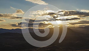 Sun rays lits thru the clouds over the valley