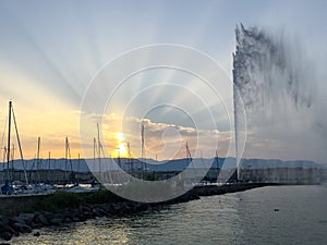 Sun rays over the Jet D'eaux in Geneva, Switzerland