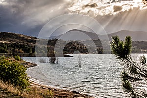 Sun Rays shining through clouds on the Hills of Lake Jindabyne,